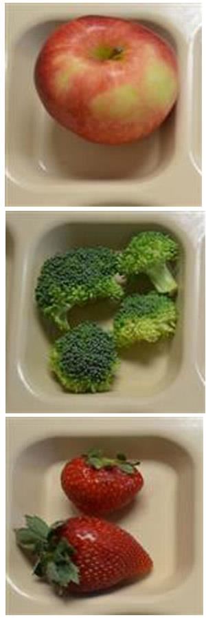 Fresh apple, broccoli and strawberries on lunch tray. 